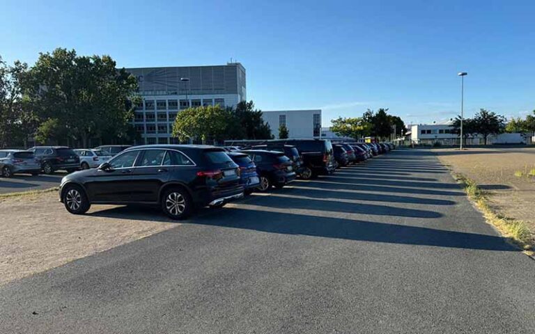 a row of cars parked in a parking lot