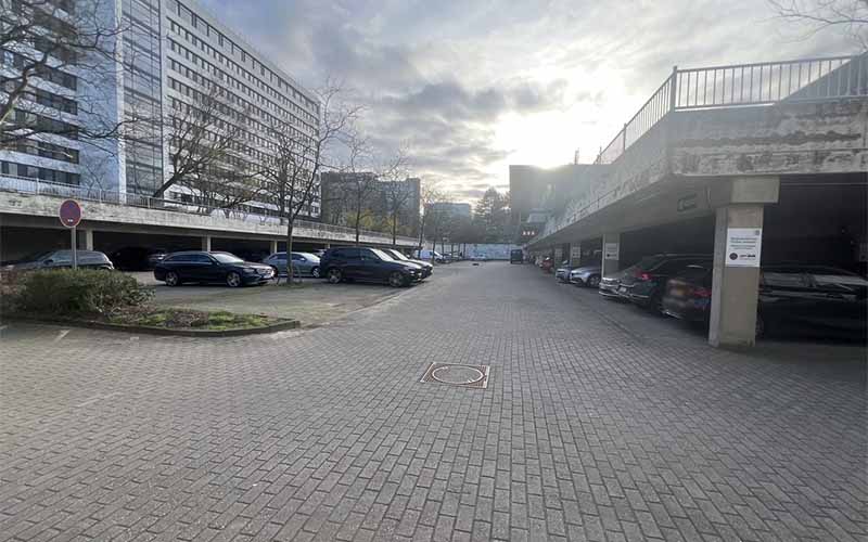 a parking lot with cars parked in front of it