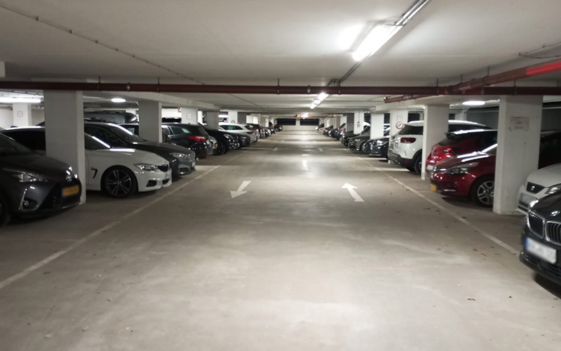 a parking garage with cars parked