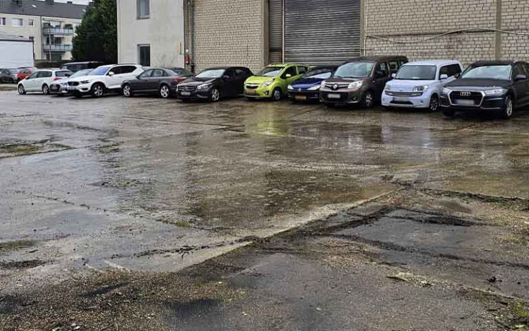 a parking lot with cars parked in front of a building