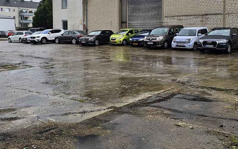 a parking lot with cars parked in front of a building