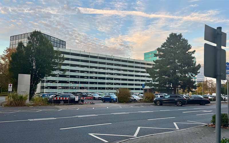 a parking lot with cars parked in front of it