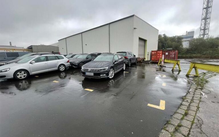 a parking lot with cars parked in front of a building