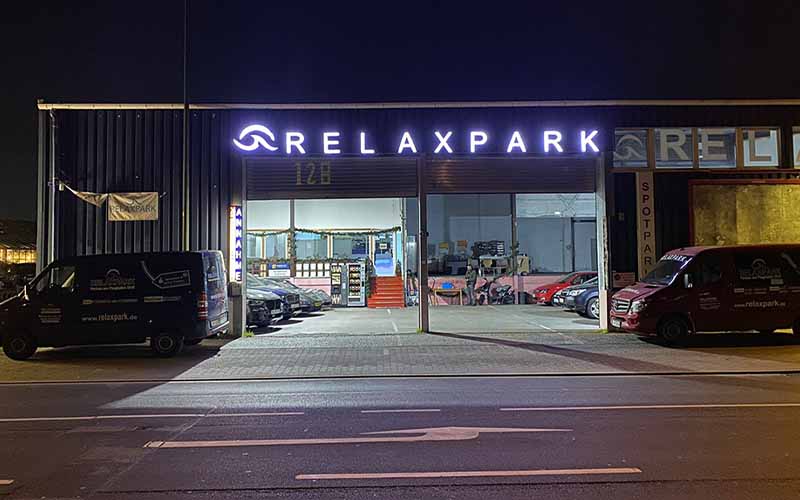 a building with a sign and cars parked in front of it